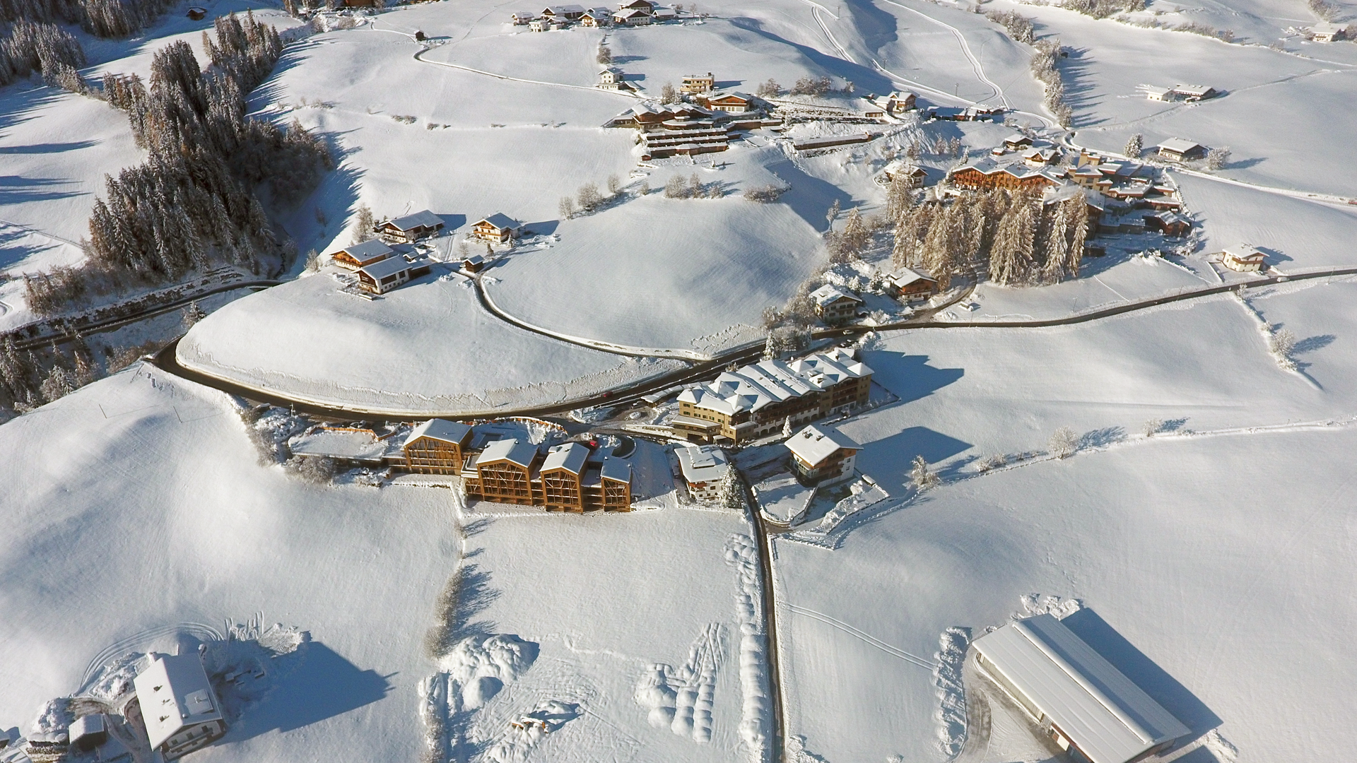 Cross-country skiing in and around Ridnaun Aerial view of a small snow-covered village with roads and buildings