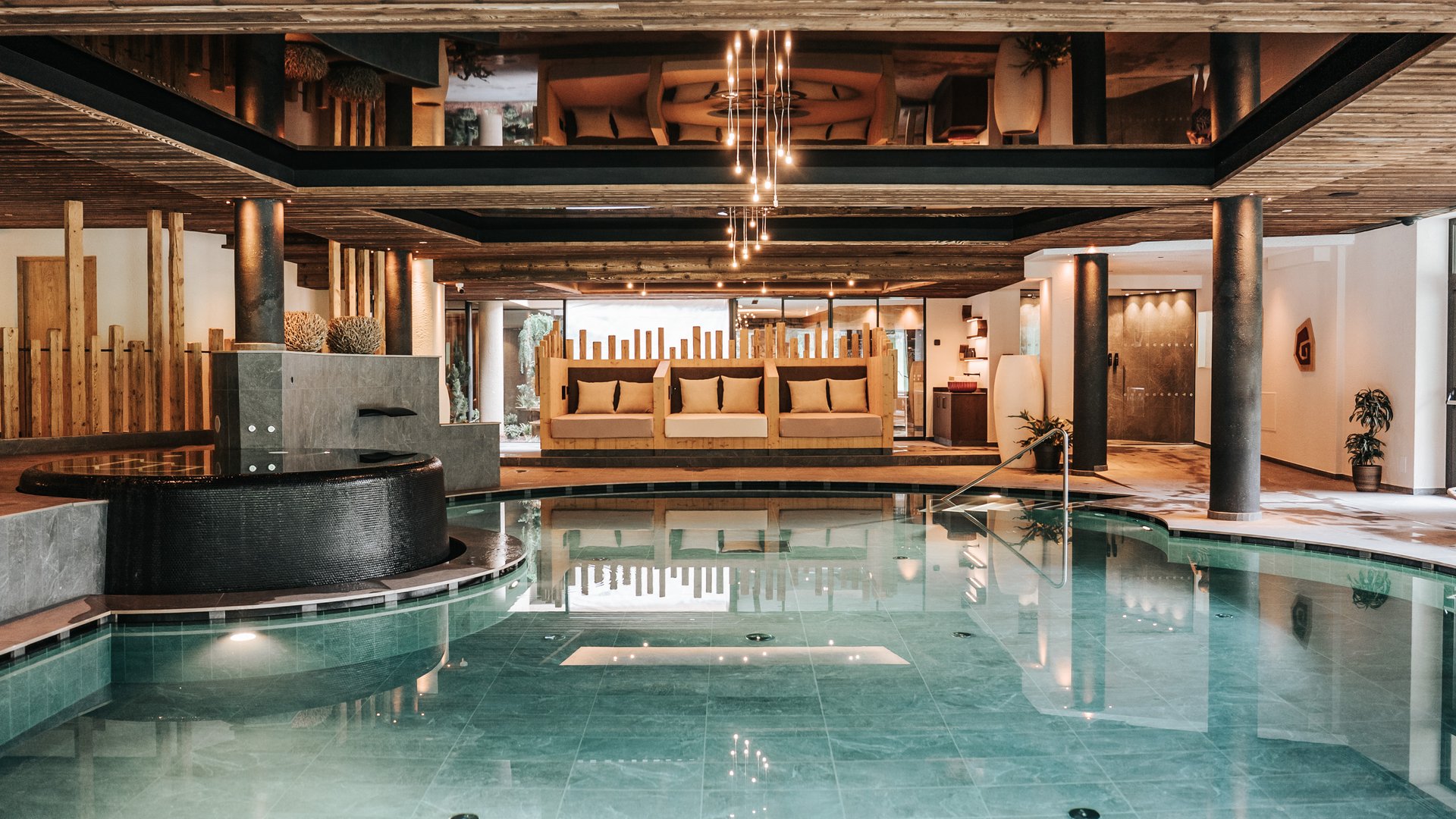 Our water world Modern indoor pool with wooden ceiling and cozy seating areas