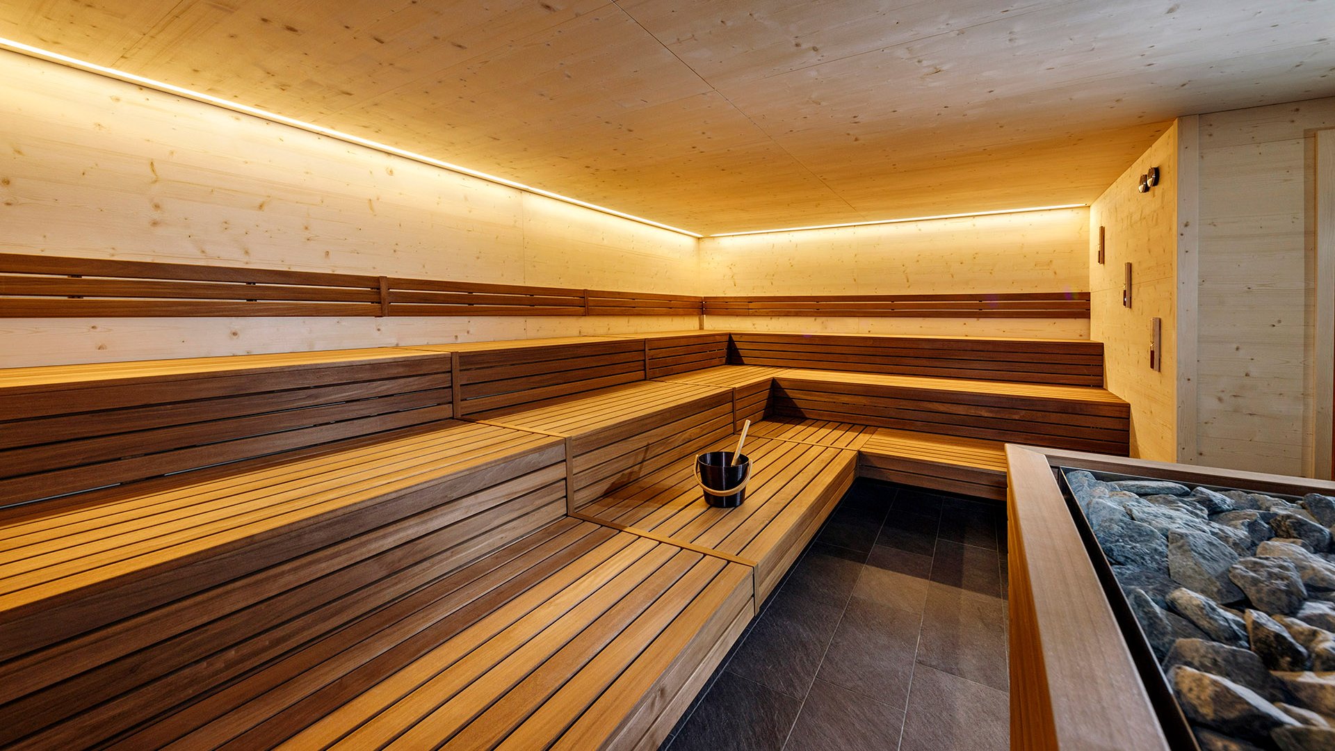 The best spot in the Ridnauntal valley Modern sauna room with wooden benches, bucket, and ladle for water infusion