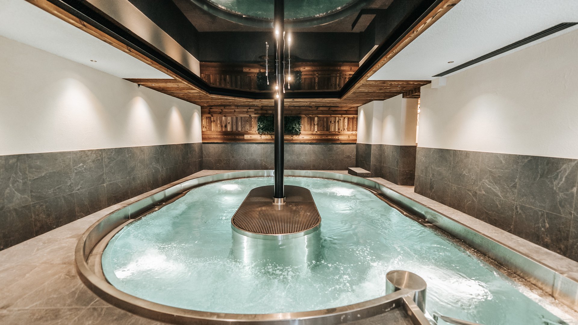 Our water world Modern indoor pool with water fountain and indirect lighting