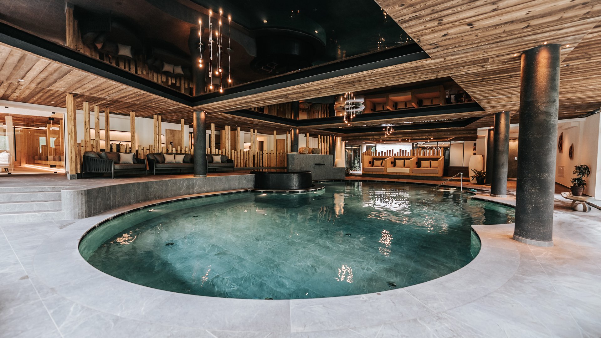 Our water world Modern indoor pool with wooden ceiling and cozy seating areas