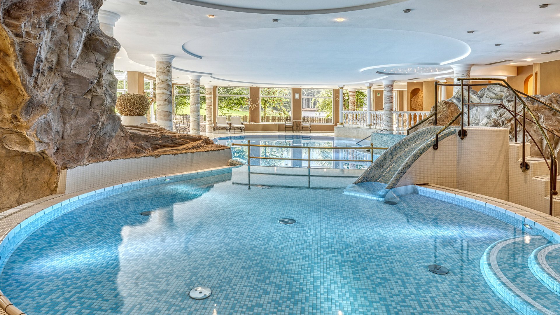 Die Wasserwelt Innenpool mit Wasserrutsche und Felsen im Wellnessbereich