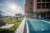 Galleria immagini Piscina esterna riscaldata con lettini e vista sulle montagne presso un hotel