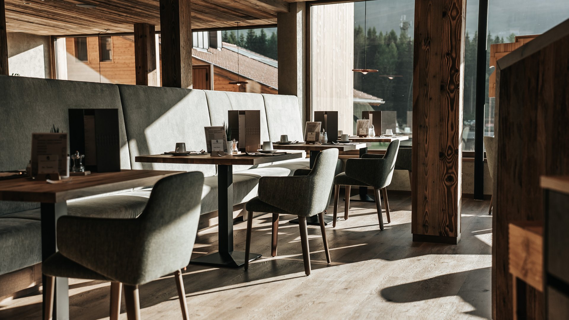 Inclusive services Modern restaurant with wooden furniture and large windows overlooking forest
