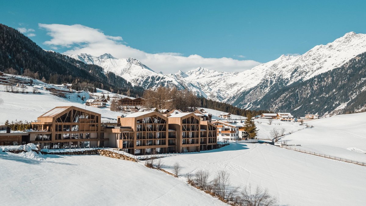 The best spot in the Ridnauntal valley Wooden buildings in snowy valley with mountains in the background