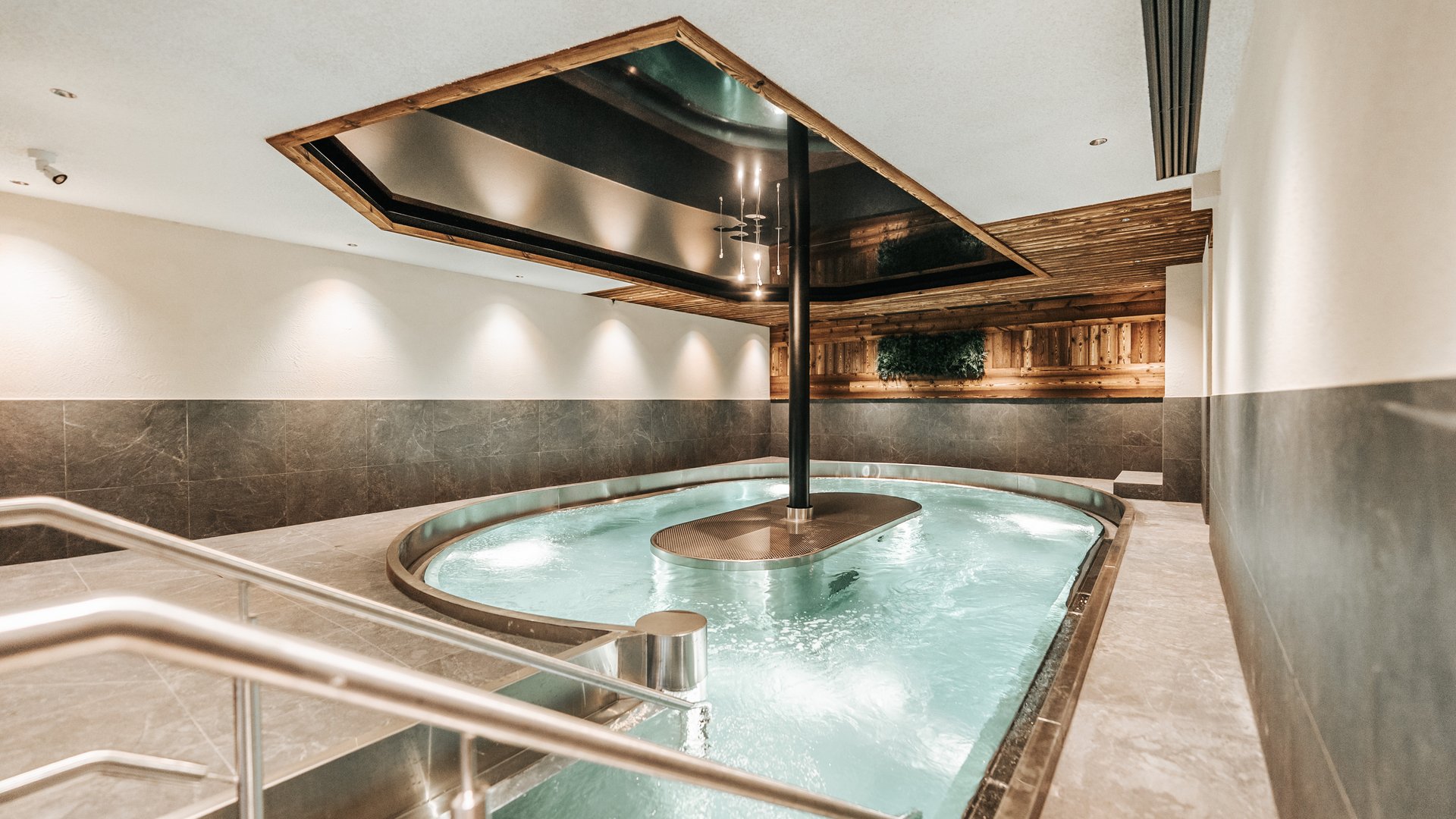 New at Gassenhof Modern indoor pool with water jets and wooden ceiling in spa area