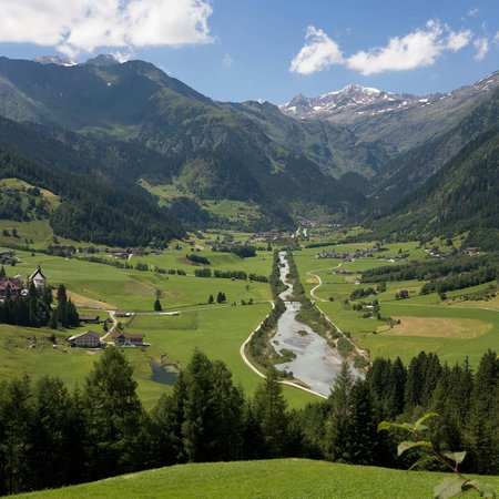 La Val Ridanna Valle con fiume, prati verdi e montagne sotto cielo azzurro