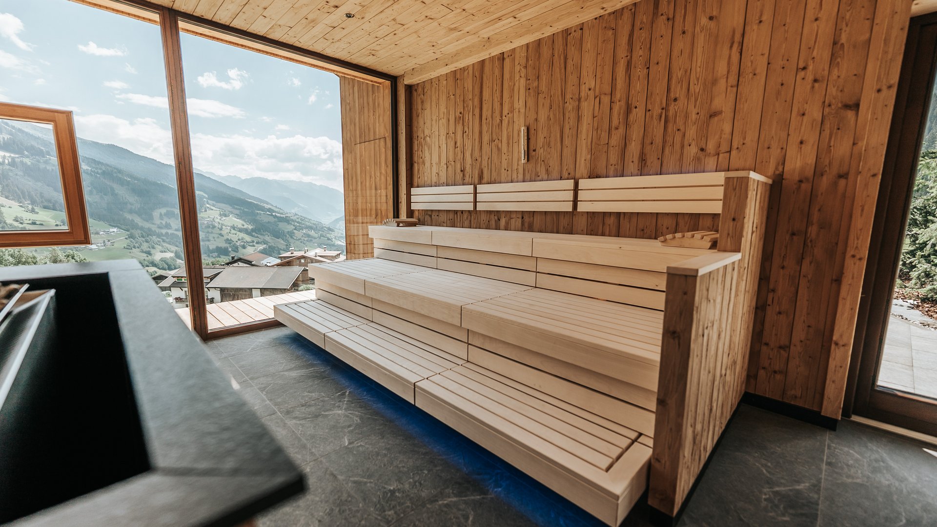 Our sauna realm Modern sauna with wooden interior and view of mountains and valley
