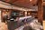 Galleria immagini Bar d'hotel rustica con bancone in granito, sgabelli, poltrone e soffitto in legno