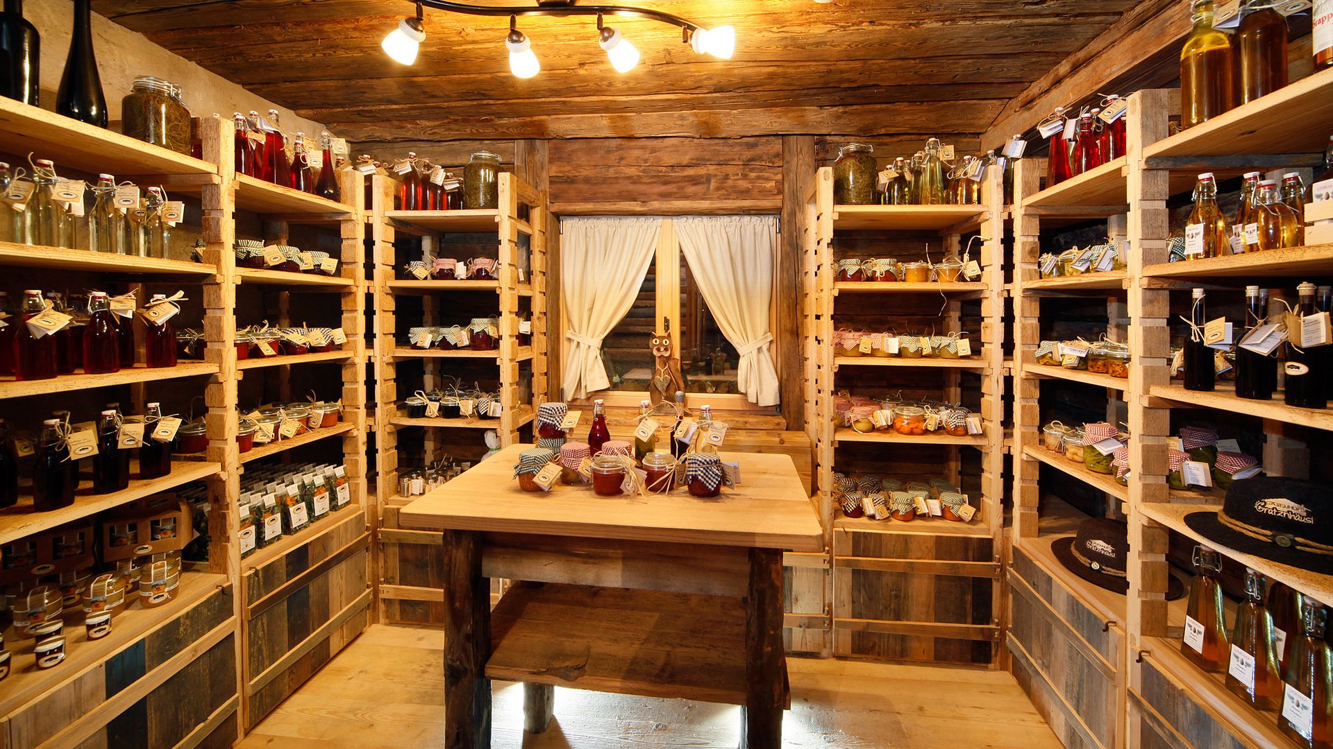 The historical Chalet Gratznhäusl Rustic pantry room with shelves stocked with preserved foods and bottles