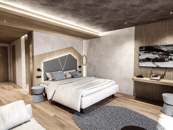 Neu ab Sommer 2026 Modernes Schlafzimmer mit Doppelbett, grauem Teppich und TV an Holzwand