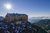 Berghütte auf Gipfel mit Sonne und Bergpanorama