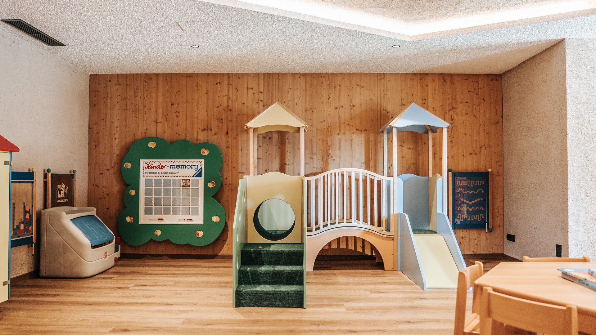 New at Gassenhof Children's playroom with slide, climbing structure, and table with chairs